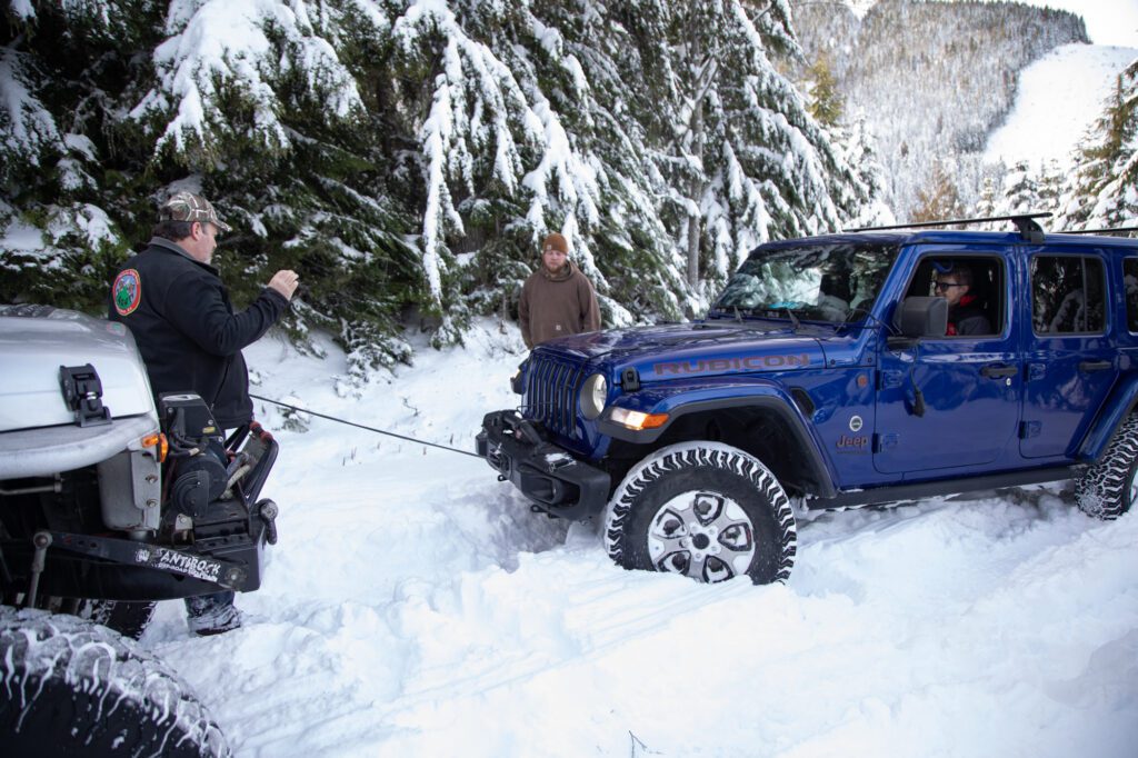 Kevin Vanderhorst helps Marilyn and Steve Foster in the blue Jeep get unstuck and turn around. Most of the vehicles are equipped with winches and ropes to help themselves and other vehicles get of ruts and potentially dangerous situations.