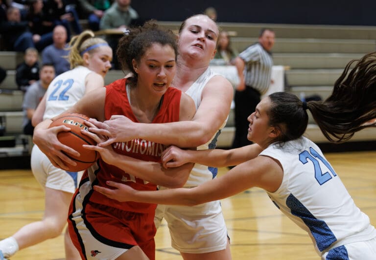 Lynden Christian’s Tabitha DeJong and Kayla Yun try to steal the ball from Snohomish's Tyler Gildersleeve-Stiles.