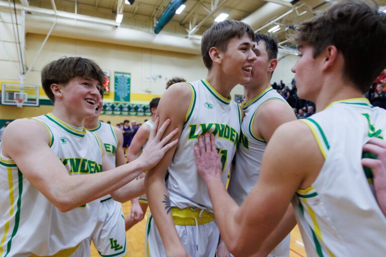Lynden players congratulate Ty Hollerman, center, after his layup was the winning basket in the Lions’ win over  Anacortes 64-62 on Jan. 24 in Lynden.