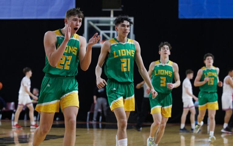 Lynden’s Brant Heppner and Anthony Canales smile as they and their teammates head to the bench for a timeout March 3 as during a game against Prosser at the 2A state tournament.