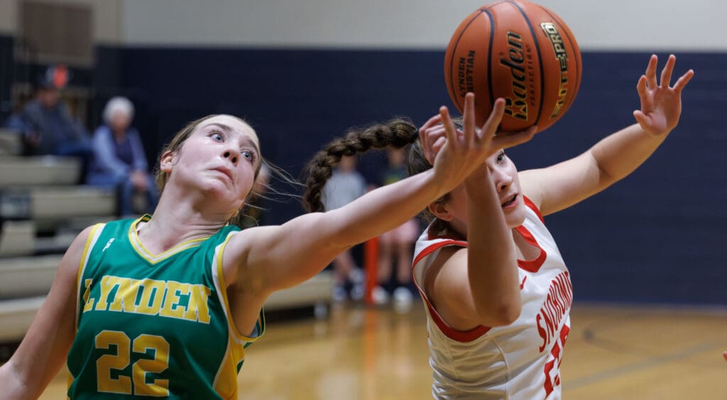Lynden’s Finley Parcher reaches for the rebound as another player tries to prevent the shot.