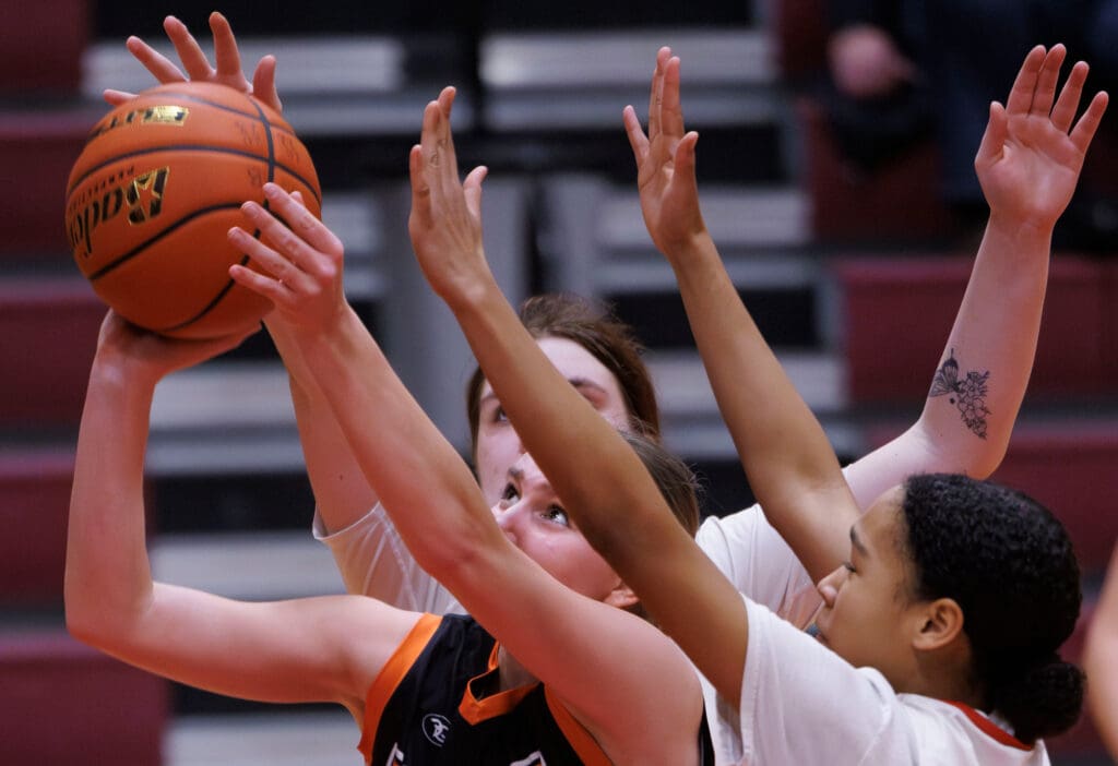 Blaine’s Amelia Berkeley reaches for the basket with the ball as other players try to block the shot from behind her.