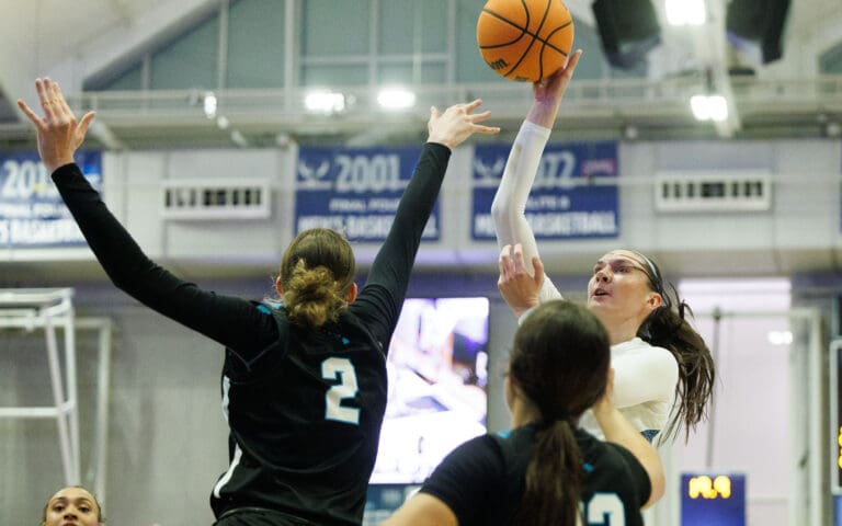Western Washington University's Brooke Walling throws up a floater as defenders leap to block the shot.