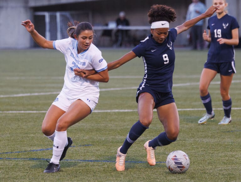 Western Washington University's Payton Neal has her arm pulled by another player as they battle for control of the ball.