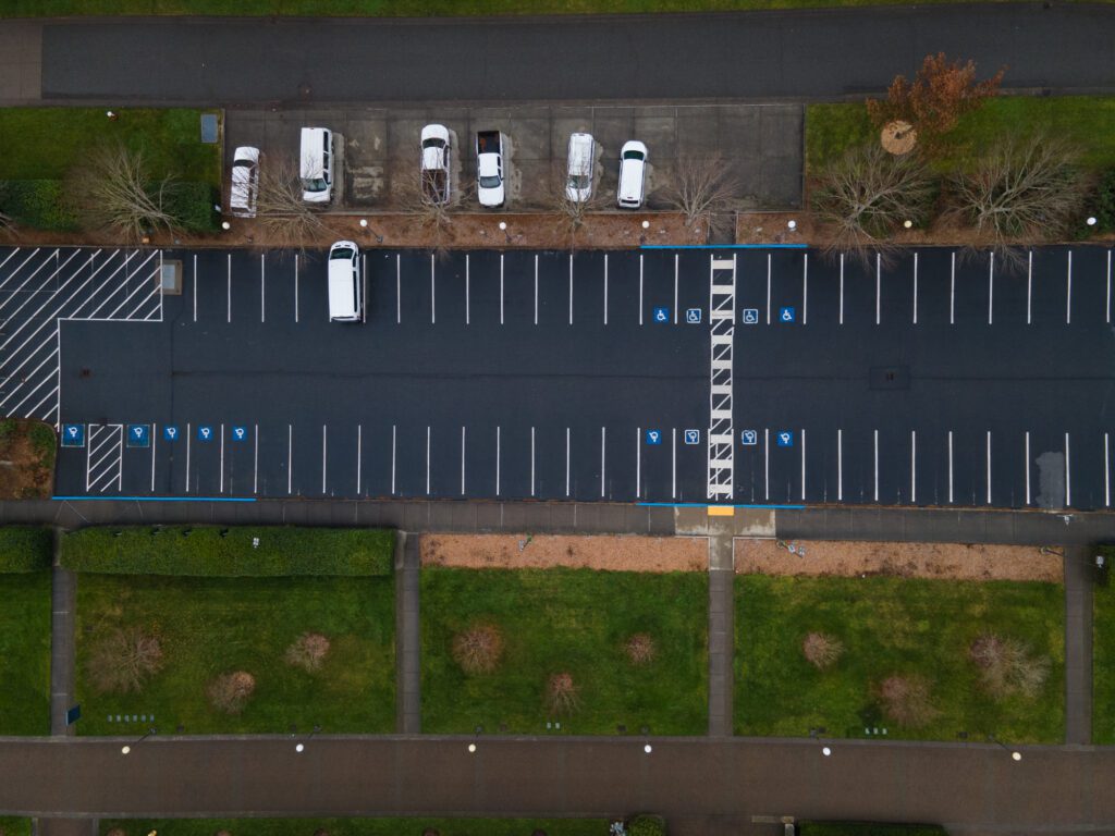 An aerial top-down view of lot 19G with one white car parked as other cars are parked on the otherside of the parking lot.