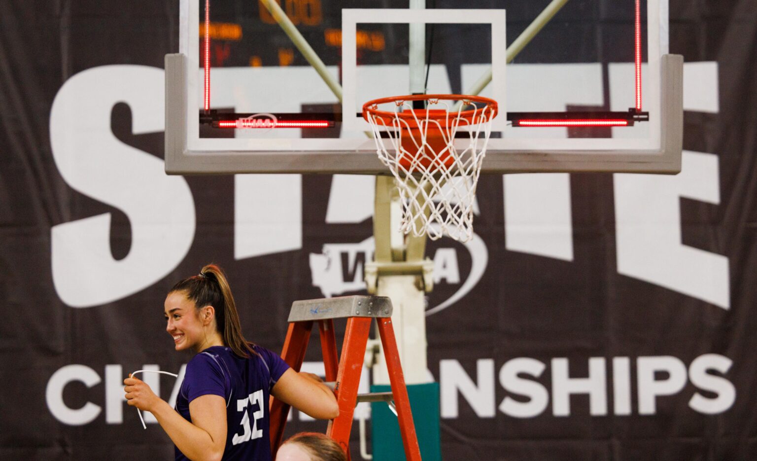 Nooksack Valley’s Taylor Lentz holds her piece of the net as she descends from the ladder.