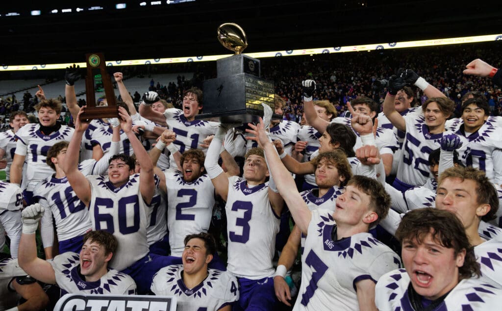 Anacortes lifts the 2A state title trophy in celebration.
