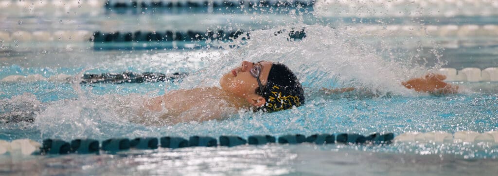 Lynden's Eugenio Sotomayor swims the backstroke as water splashes over him from his hand diving back into the water.