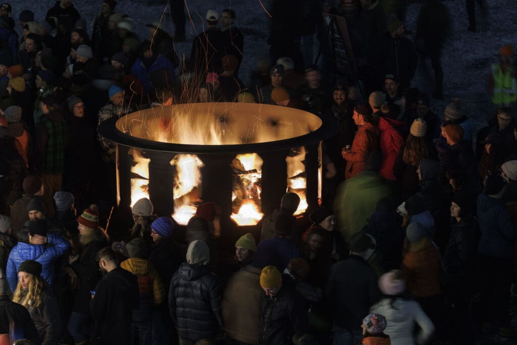 Audience members surround a spinning fire pit at the Fire and Story Festival.