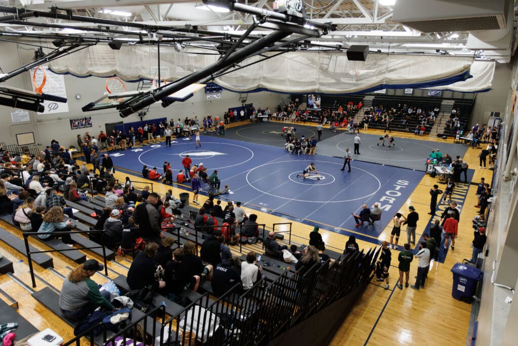 Wrestlers compete on four mats at the same time during the Graham Morin Memorial Wrestling Tournament.