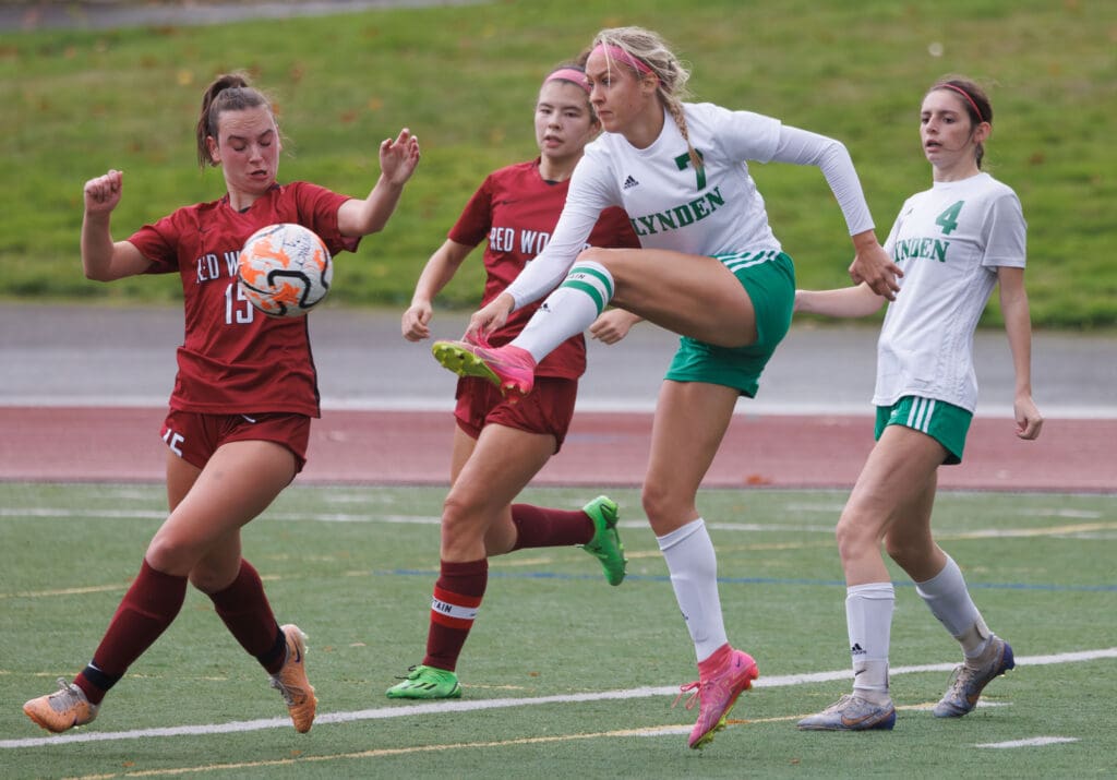 Lynden’s Mallary Villars kicks the ball as she looks to score the goal while other players brace around her.
