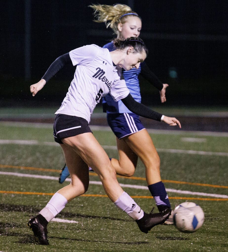 Meridian’s Erica Stotts looks to score a goal as another player looks to steal the ball.