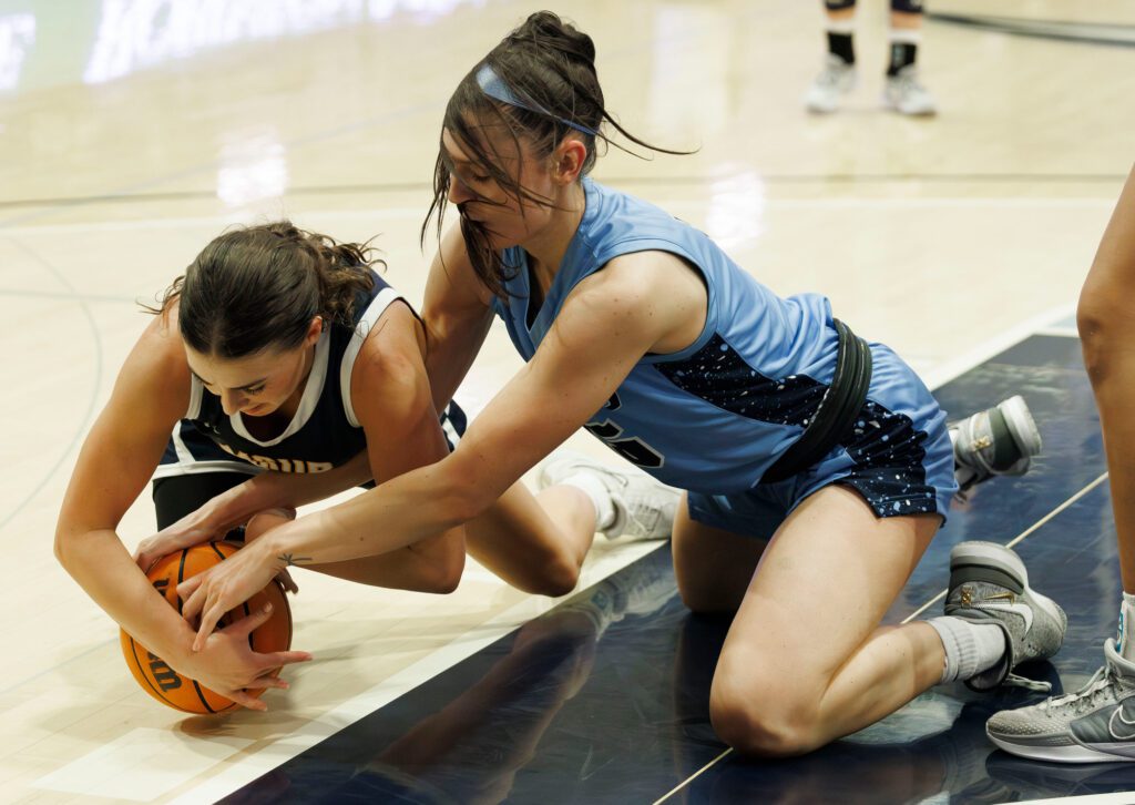 Western Washington University's Brooke Walling fights for the ball with a Montana State University-Billings player during Saturday’s game.