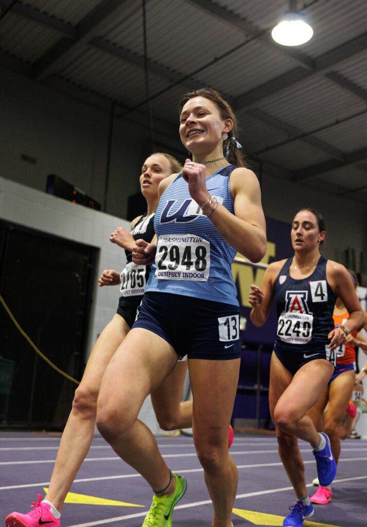 Western Washington University's Ila Davis runs alongside other runners on the indoor track.
