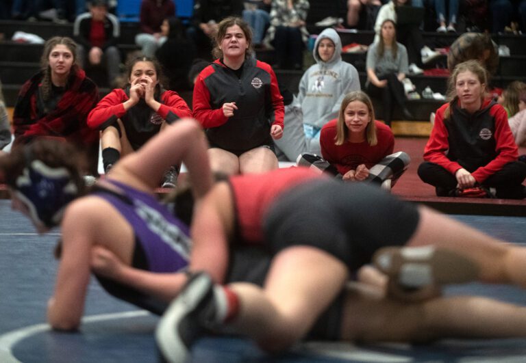 Mount Baker's wrestlers cheer on Melanie Wilson from the sideline during her match against Alita Ciron-penton Saturday, Feb. 4 during the 3rd and 5th round of girls subregional wrestling tournament at Squalicum High School. Wilson defeated Ciron-penton 9-7 in the 140 lbs weight class.