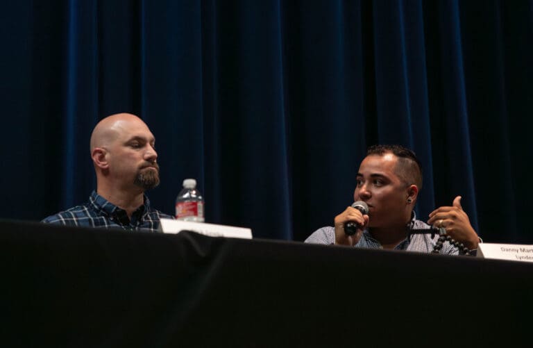 Danny Martinez and Nick Sawka sitting at a panel as they answer questions