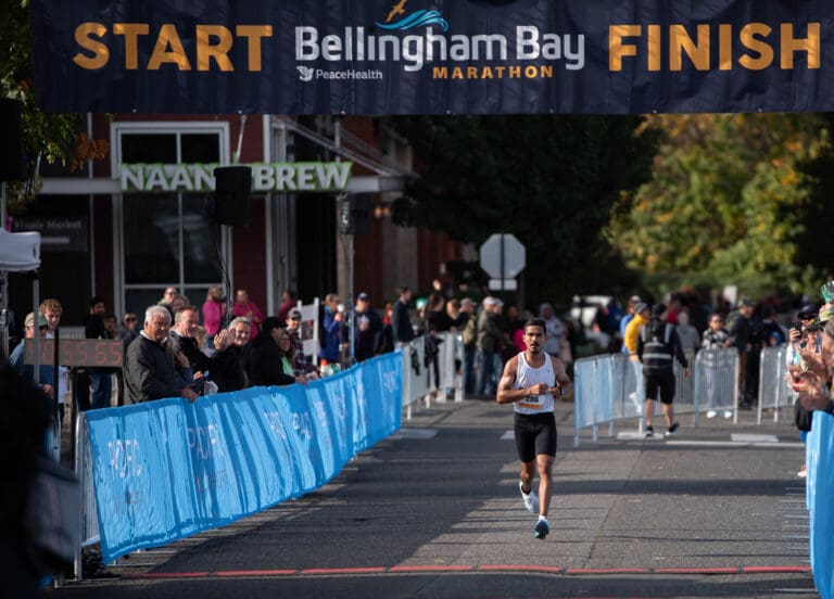 Adrian Cedillo crosses the finish line at the Bellingham Bay Marathon Sunday