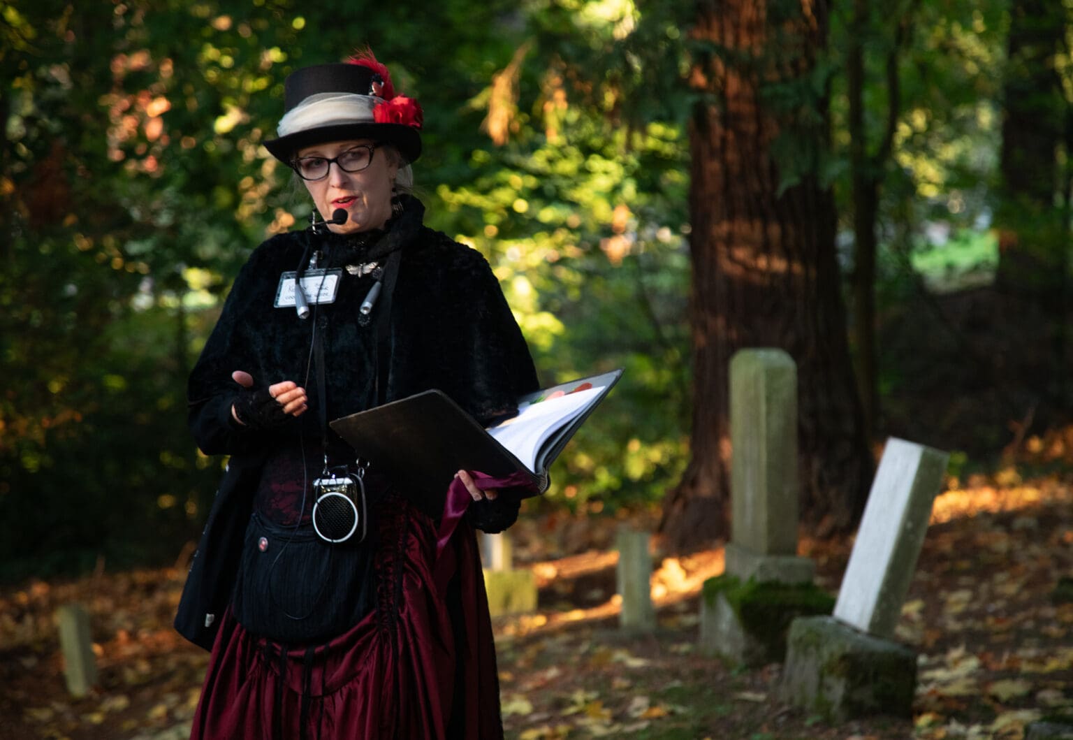 Kolby LaBree of the Good Time Girls tells the history of a gravesite while wearing a kilt.