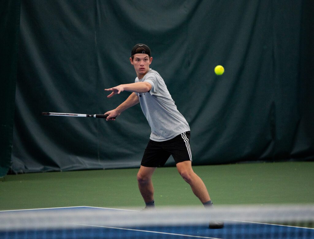 Bellingham's Jacob Kuhn watches the ball as he gets ready to hit it with his racket.