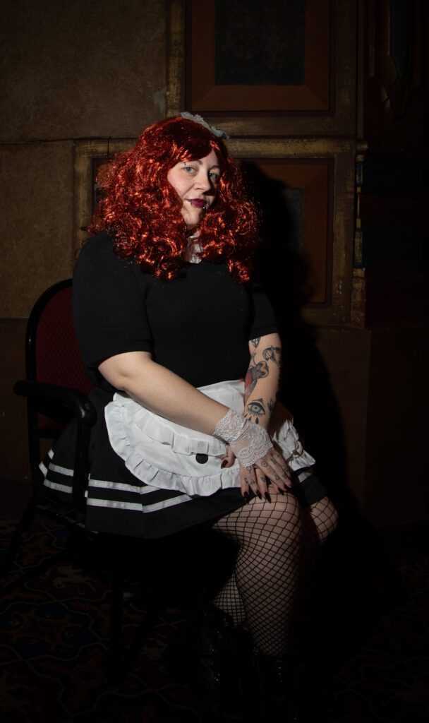 "The Rocky Horror Picture Show" veteran Desi Williams poses for a photo, dressed in a maid costume.