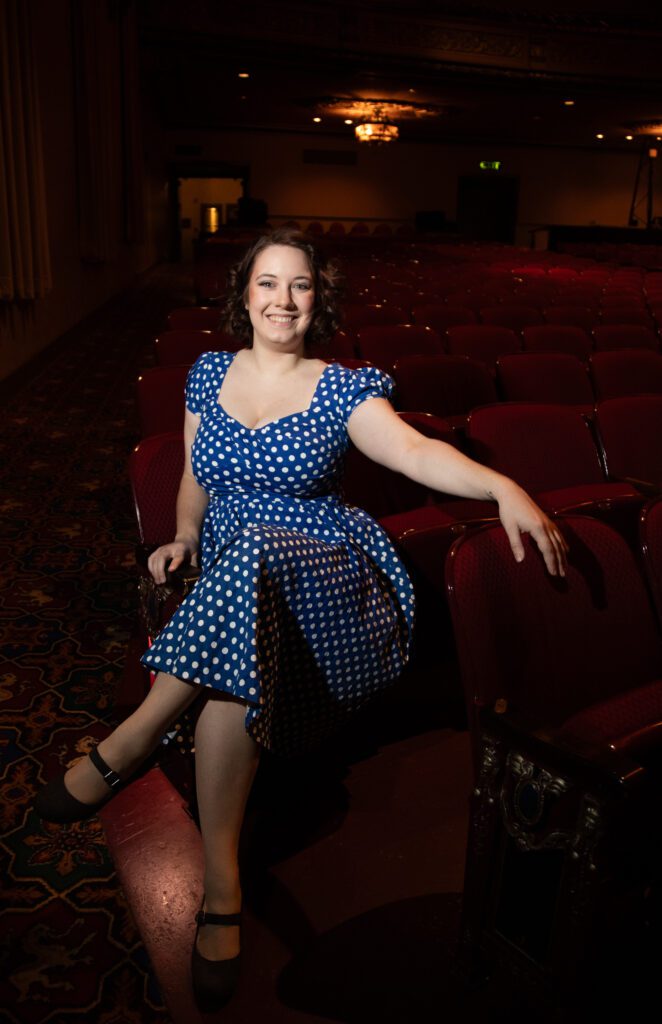 Kennedy Rainer poses for a photo in one of the many seats meant for the audience.