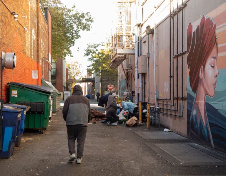 People gather in the alley between Railroad Avenue and Cornwall Avenue on Oct. 30.  Exploring the problems and solutions for homelessness will be a priority for CDN's newsroom in the coming year