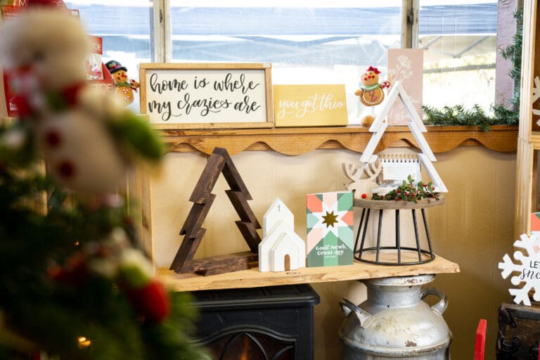 Decorations, ornimants and cards adorn the small gift shop below a window.