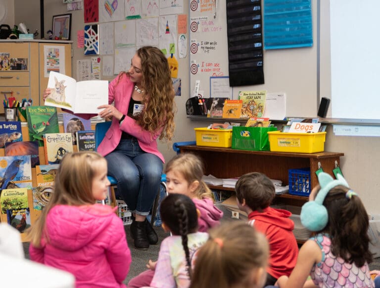 Bellingham author Stefanie Fields opens up her book to show the children and reads "You're Beautiful When" to kindergarteners.