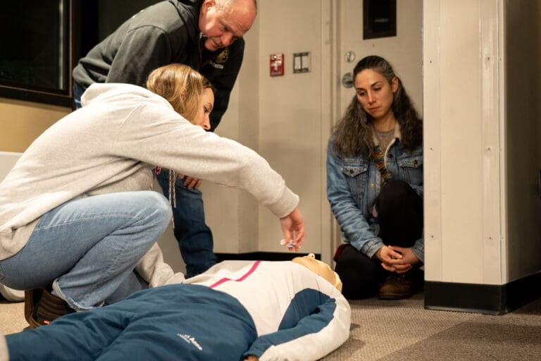 Bailey Rahn rehearses administering naloxone to a dummy during a Dec. 6