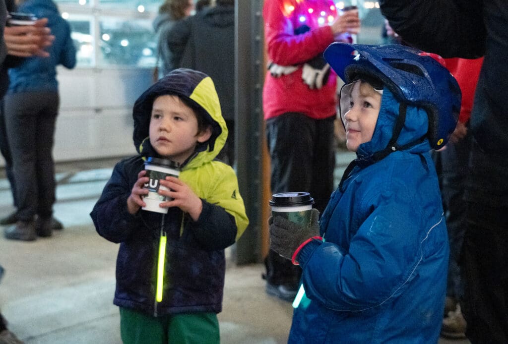 Vannier Morrison, right, and Teslow Morrison hold cups of hot cocoa inside the Market Depot.