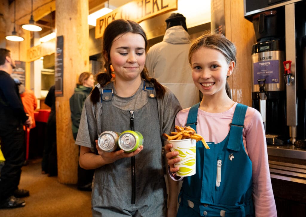 Elise Tuininga, left, and Emma Flattery get drinks and Duncan's Hand Cut Fries at Raven Hut.