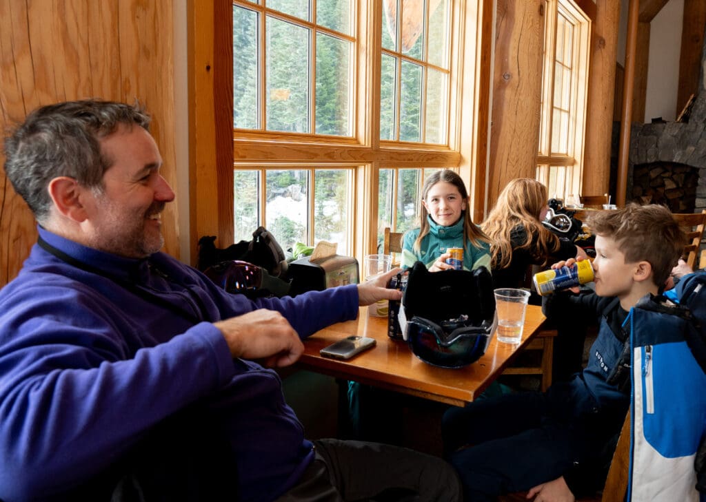 WMBC Executive Director Eric Brown, left, and his kids, Cleo Brown, middle, and Wylie Brown have drinks in Raven Hut on opening day.