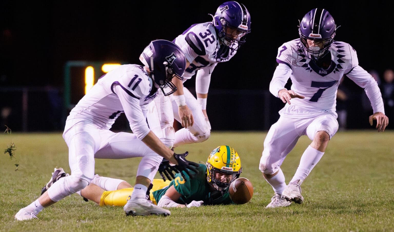 Anacortes players converge on the ball for a fumble recovery Oct. 27 as Lynden’s Bradey Elsner watches the play. Anacortes is on to the 2A state championship game after defeating Enumclaw in the state semifinals