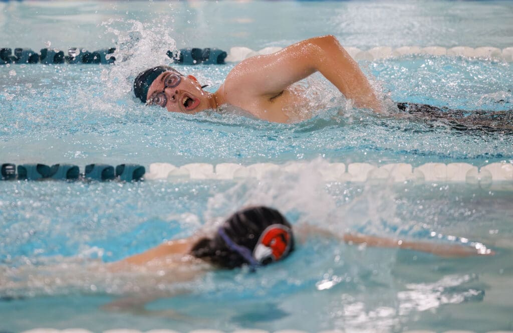 Lynden's Eugenio Sotomayor stays ahead as he passes by another swimmer on his way back.