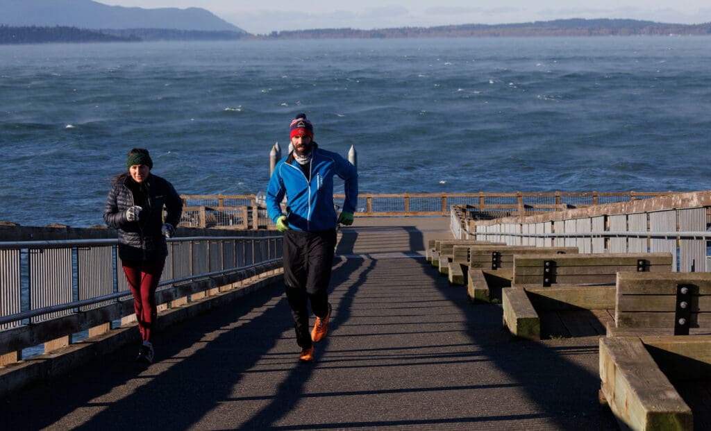 Alanna Steele and Adam Airoldi run up Taylor Dock dressed in winter clothes to brave the cold.