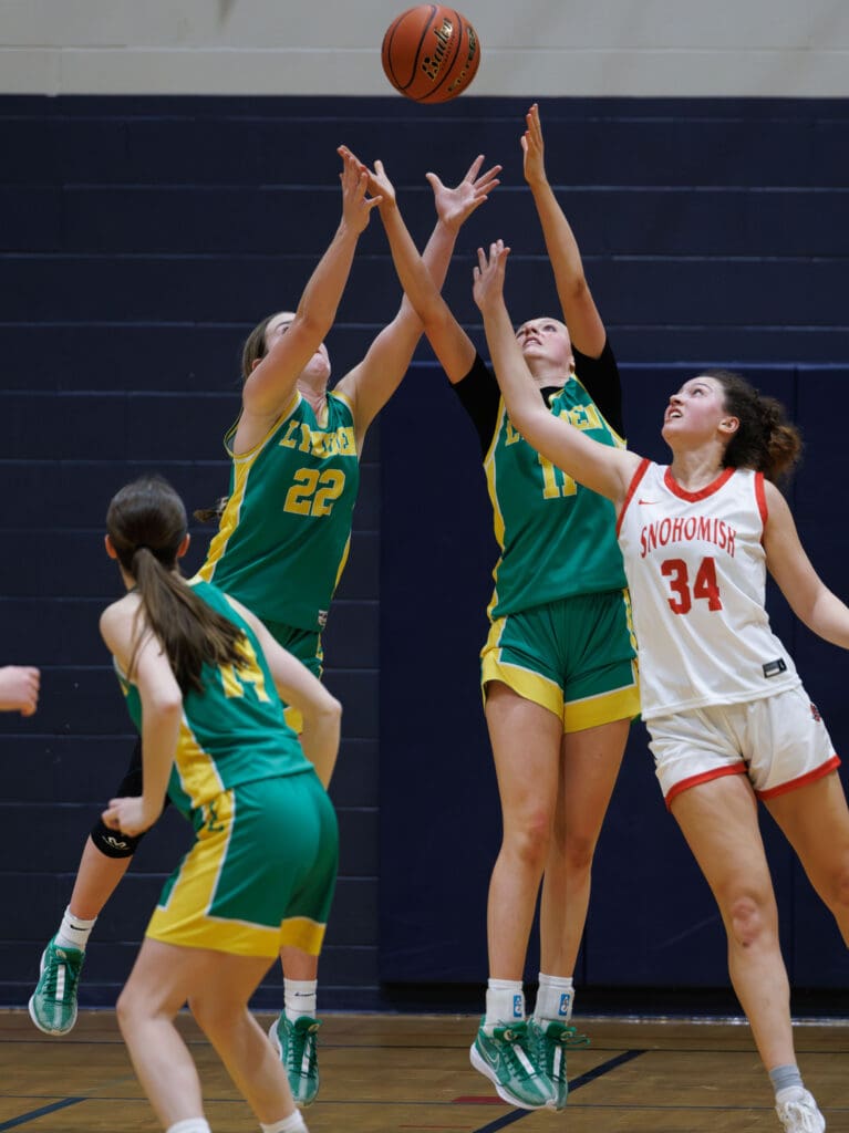 Lynden’s Finley Parcher (22) and Rian Stephan reach to interrupt a Snohomish pass.