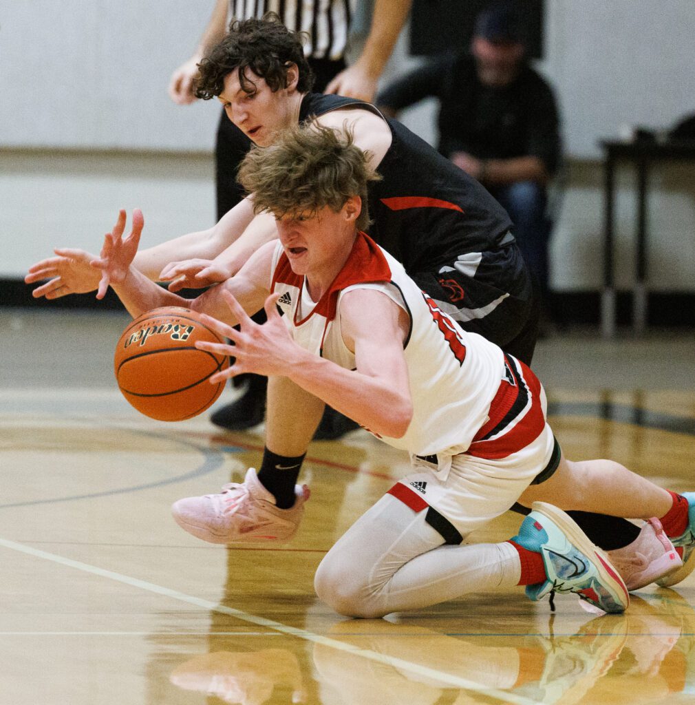 Mount Baker’s Joe Harward and Bellingham’s Joshua Tolle dive for a loose ball as one of them falls to the ground with the ball in between his hands.