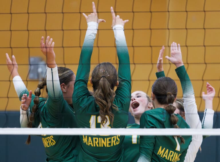 Sehome players celebrate a lead in the first set Sept. 6 during a match against Lynden.