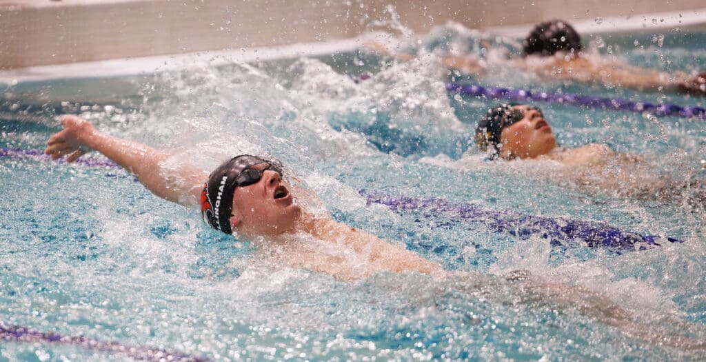Bellingham's Miles Cratsenberg laps the field alongside two other swimmers.