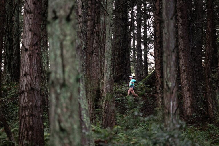 A runner competes in a trail race in the Chuckanuts in March 2022. Human threats can be present even on heavily trafficked community trails. Pre-trip research