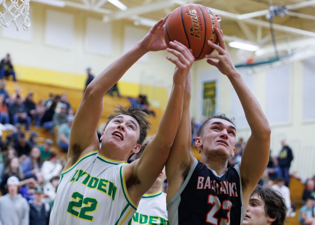 Lynden’s Brant Heppner and Bellingham’s Elias Togagae battle for a rebound as they both reach for the ball.