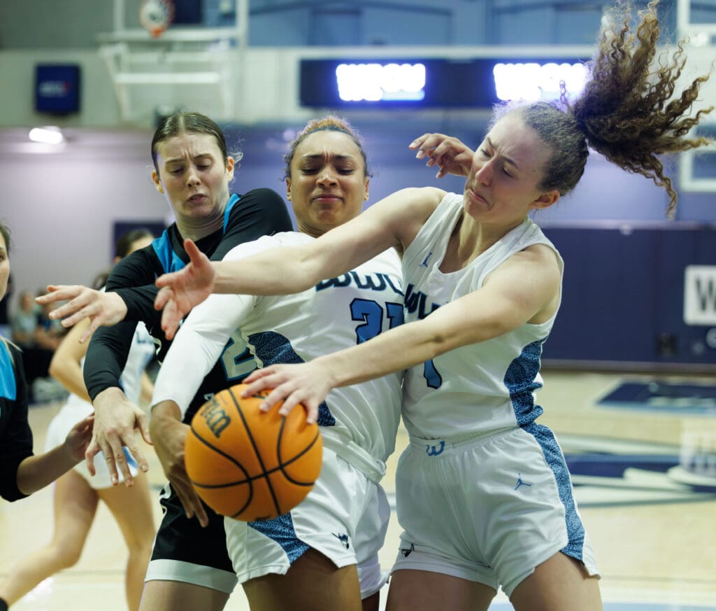 Western's Jadyn Watts and Olivia Wikstrom battle for the rebound as her hair flies up from the shove.