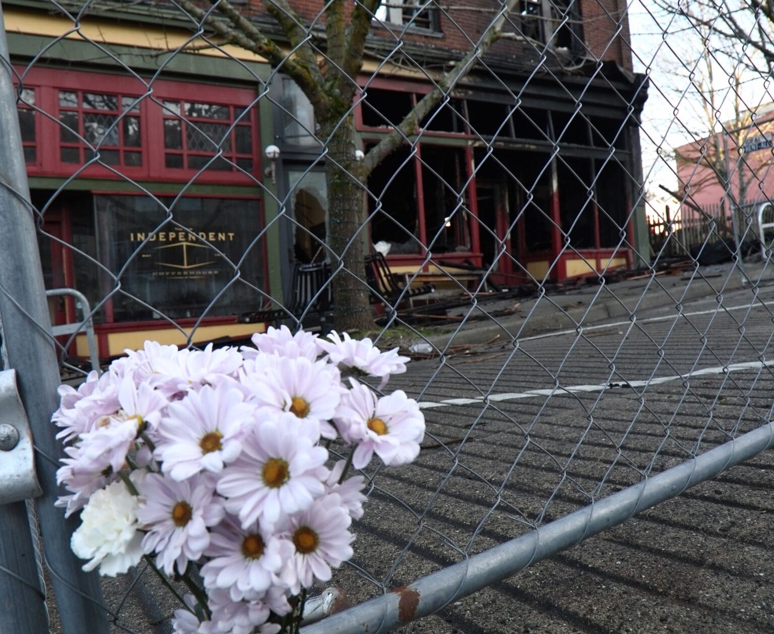 Flowers sit outside the burned Terminal Building in Fairhaven