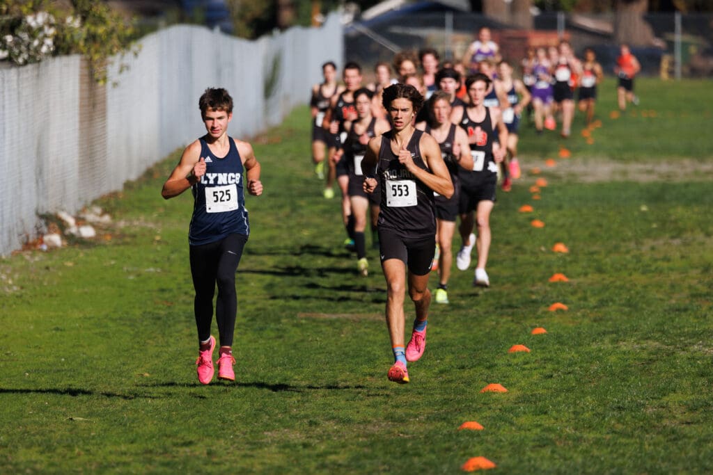 Lynden Christian's Nickolas Luce leading the group as another runner is by his side.
