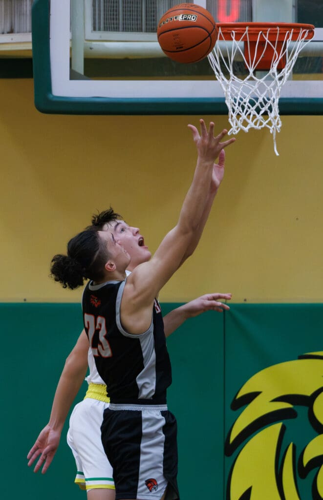 Lynden’s Brant Heppner tries to block a shot by Bellingham’s Elias Togagae as the ball hits the rim of the basket.