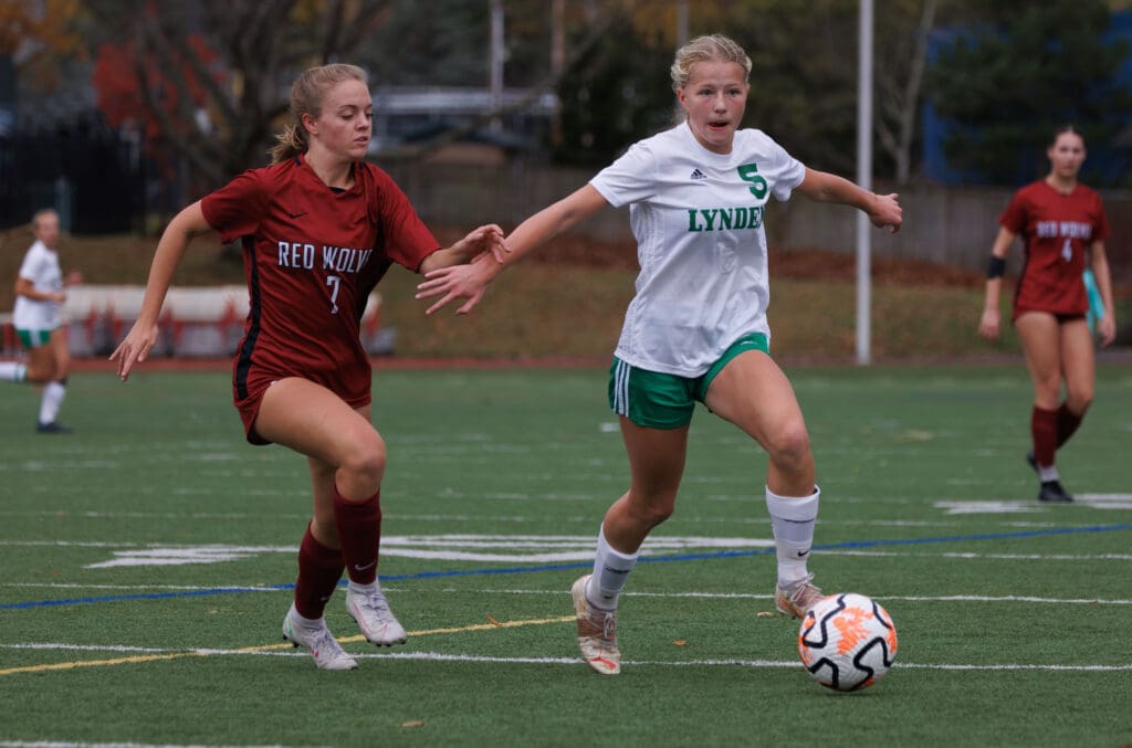 Lynden’s Rilanna Newcomb takes the ball upfield as another player looks to steal the ball.