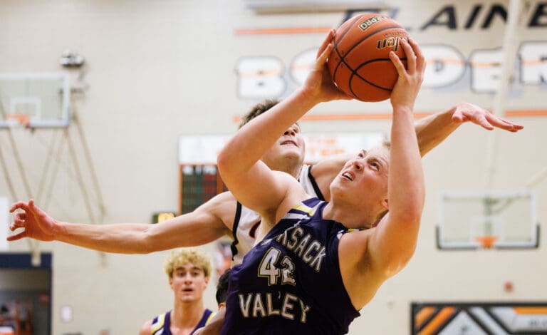 Nooksack Valley's Brady Ackerman looks up to take a shot as a defender attempts to swat the ball away.