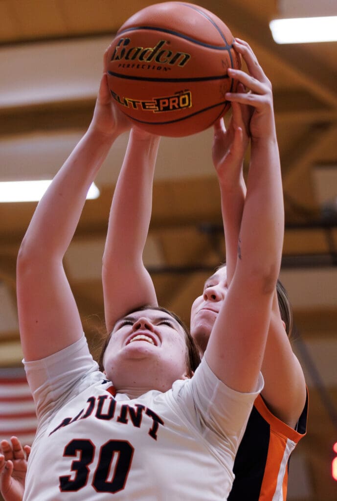 Mount Baker’s Jenna Wineinger and Blaine’s Jordyn Vezzetti battle for the rebound as they both hold onto the ball.