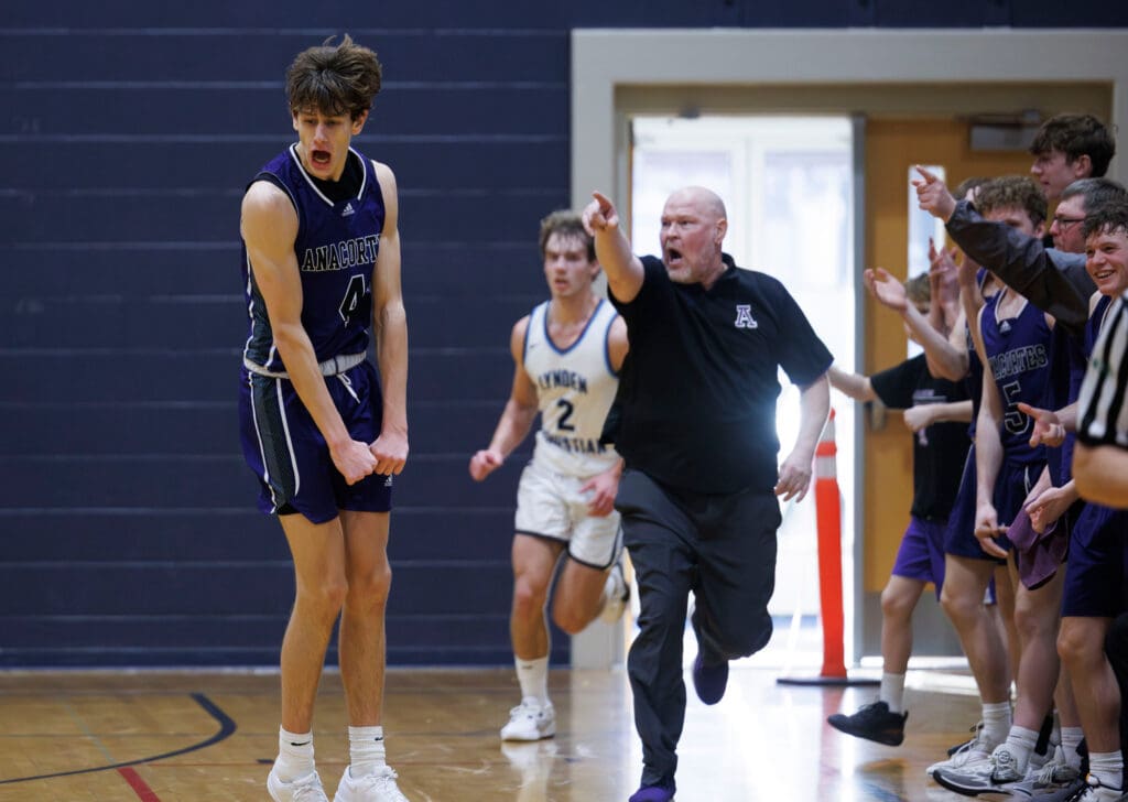 Anacortes’ Davis Fogle and the Seahawks bench celebrate as they take the lead while their coach points and runs along the celebrating member.