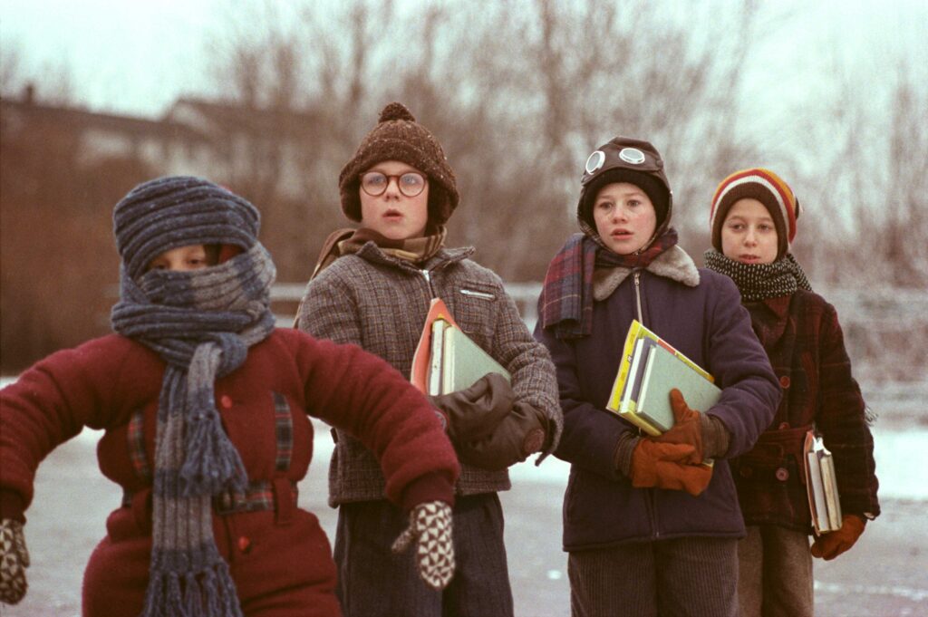 A scene from “A Christmas Story” of the four children wearing heavy winter clothes.